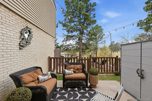 a view of a patio with a table and chairs