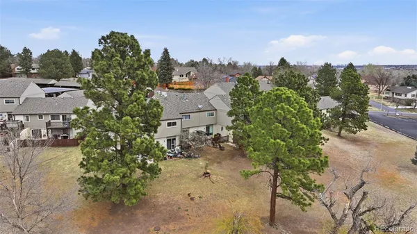an aerial view of residential houses with outdoor space and lake view