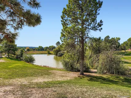 a swimming pool with outdoor seating and yard
