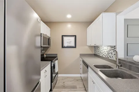 a kitchen with a sink and a refrigerator