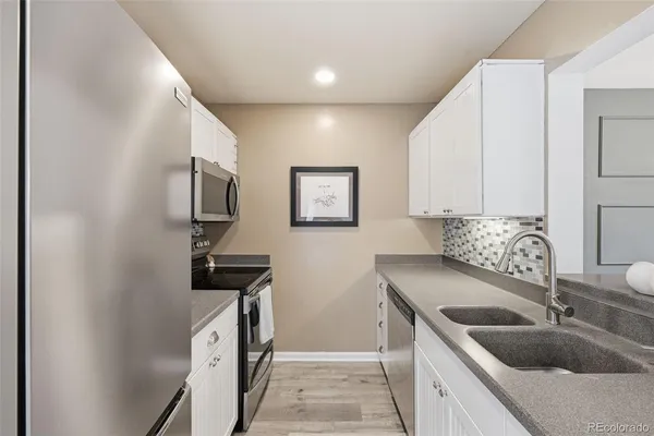a kitchen with a sink and a refrigerator
