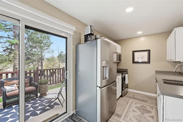 a kitchen with stainless steel appliances granite countertop a refrigerator and a sink