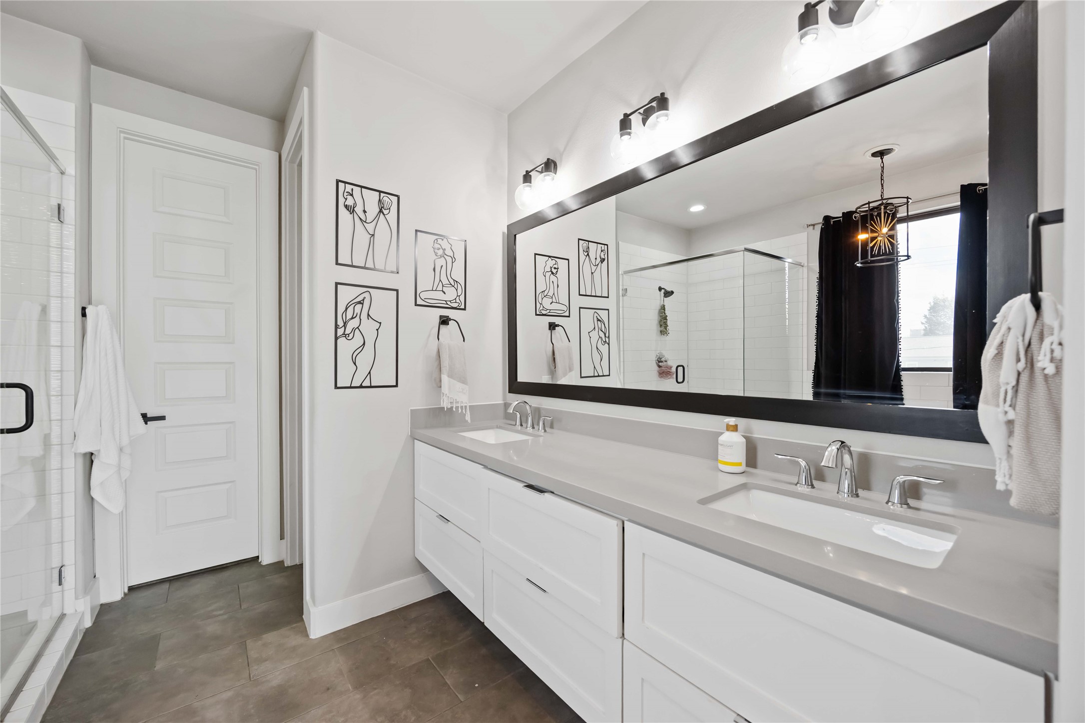 4235 Allen Street Houston, TX 77007 - Photo 14 of 23 a bathroom with double vanity sinks and a large mirror