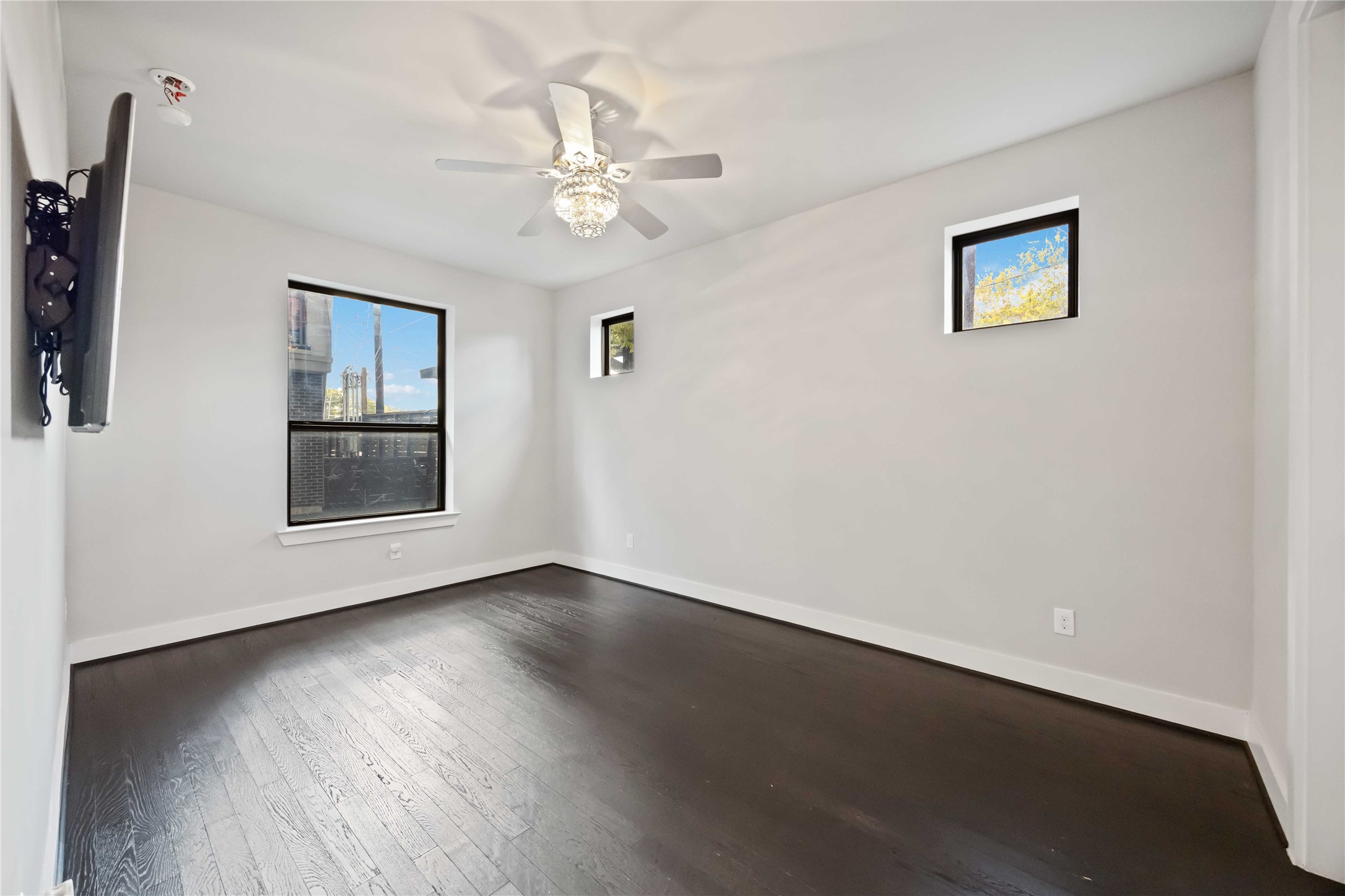 4235 Allen Street Houston, TX 77007 - Photo 19 of 23 a view of an empty room with wooden floor and a ceiling fan