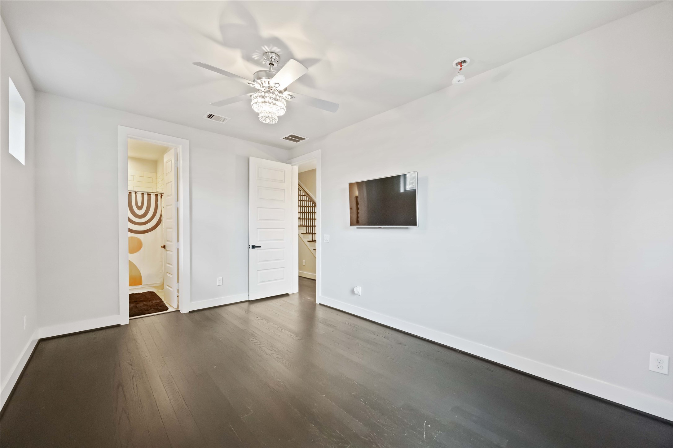 4235 Allen Street Houston, TX 77007 - Photo 20 of 23 an empty room with wooden floor fan and windows