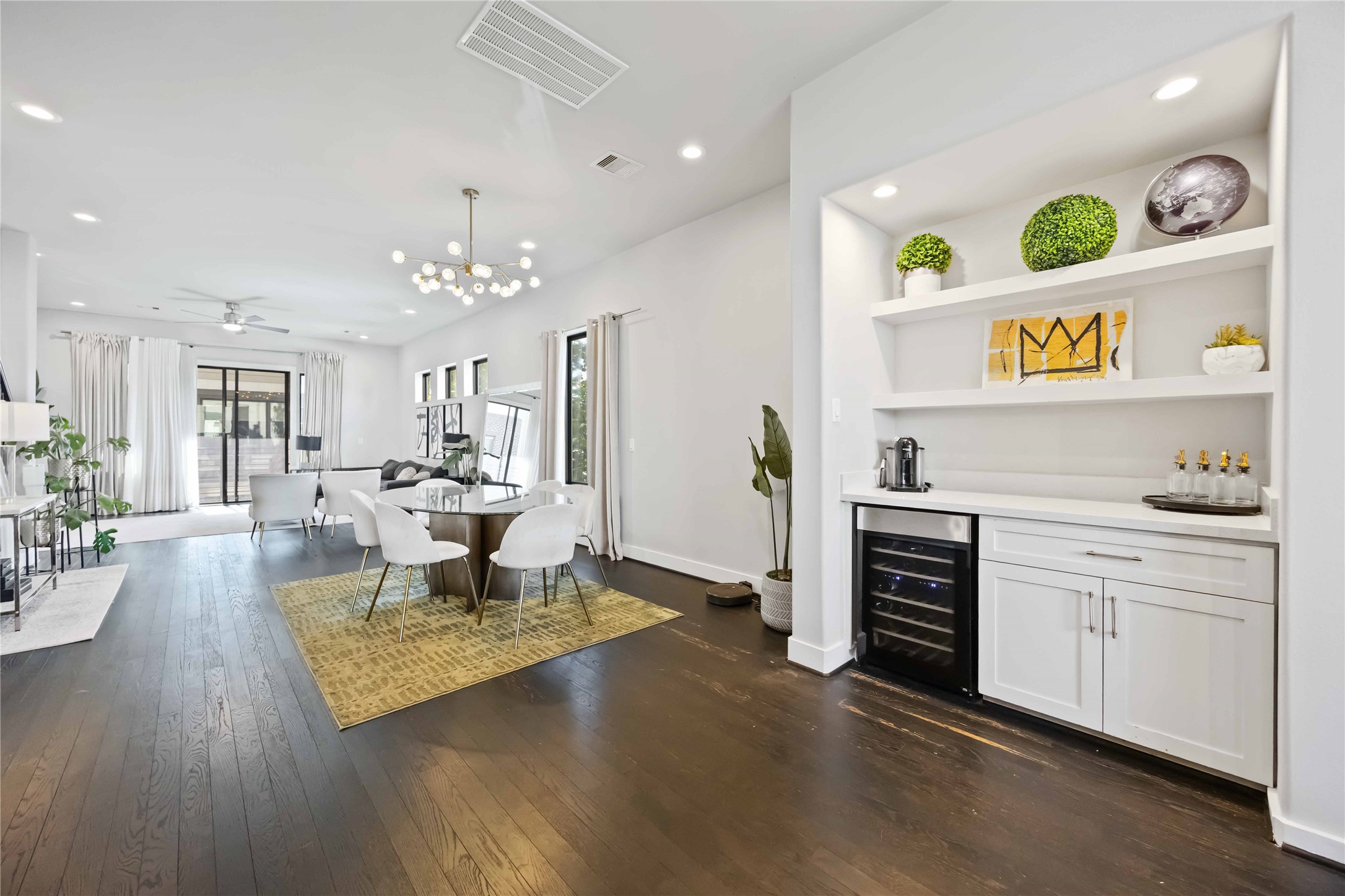4235 Allen Street Houston, TX 77007 - Photo 4 of 23 a open kitchen with stainless steel appliances granite countertop a stove top oven a dining table and chairs with wooden floor