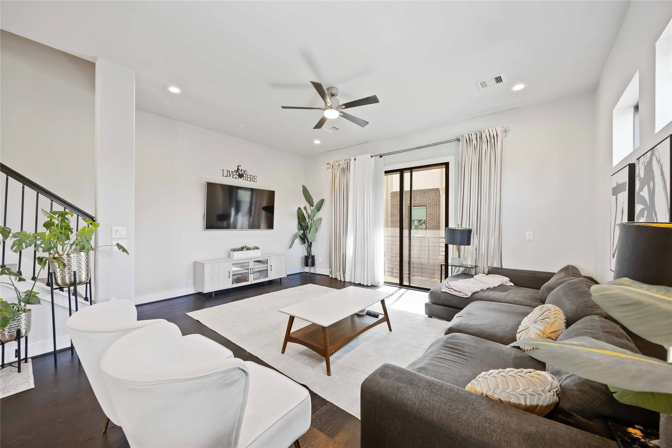 4235 Allen Street Houston, TX 77007 - Photo 6 of 23 a living room with furniture ceiling fan and a flat screen tv