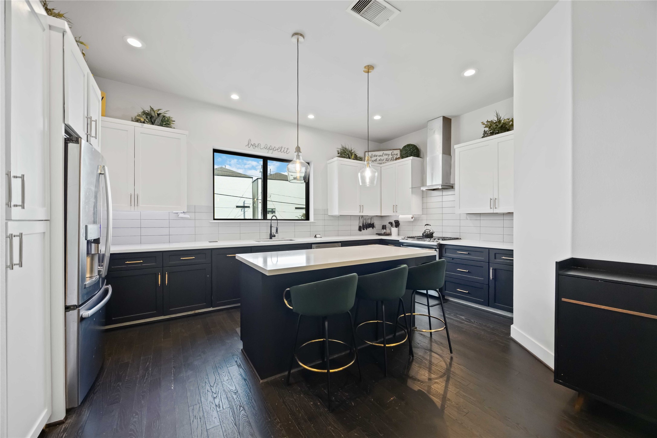 4235 Allen Street Houston, TX 77007 - Photo 7 of 23 a kitchen with kitchen island granite countertop a sink a counter space appliances and a window