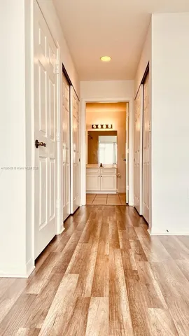 a view of a room with wooden floor and door
