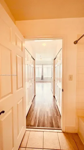 a view of a room with wooden floor