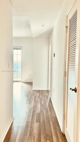 a view of a room with wooden floor and bathroom