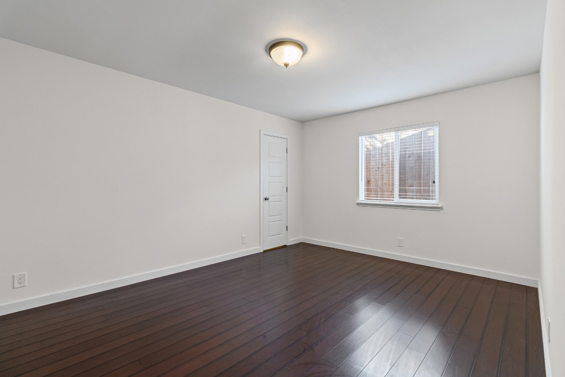 6305 Vioitha Drive, Unit B Austin, TX 78723 - Photo 11 of 23 a view of an empty room with wooden floor and a window