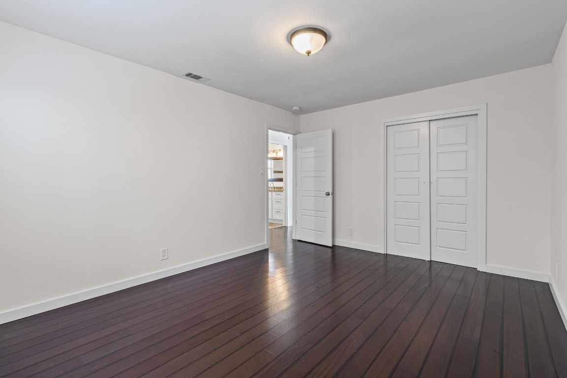6305 Vioitha Drive, Unit B Austin, TX 78723 - Photo 12 of 23 a view of an empty room with wooden floor