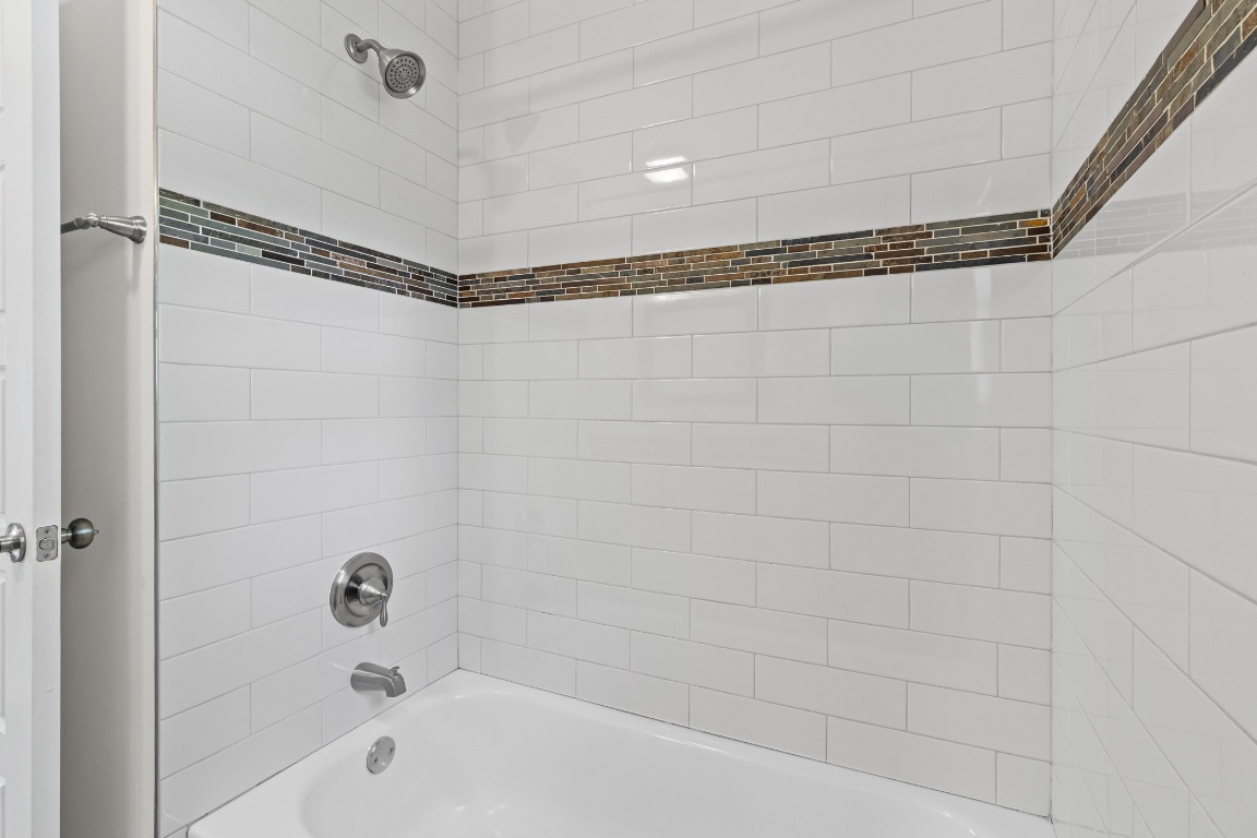 6305 Vioitha Drive, Unit B Austin, TX 78723 - Photo 15 of 23 a bathroom with a shower and a bathtub