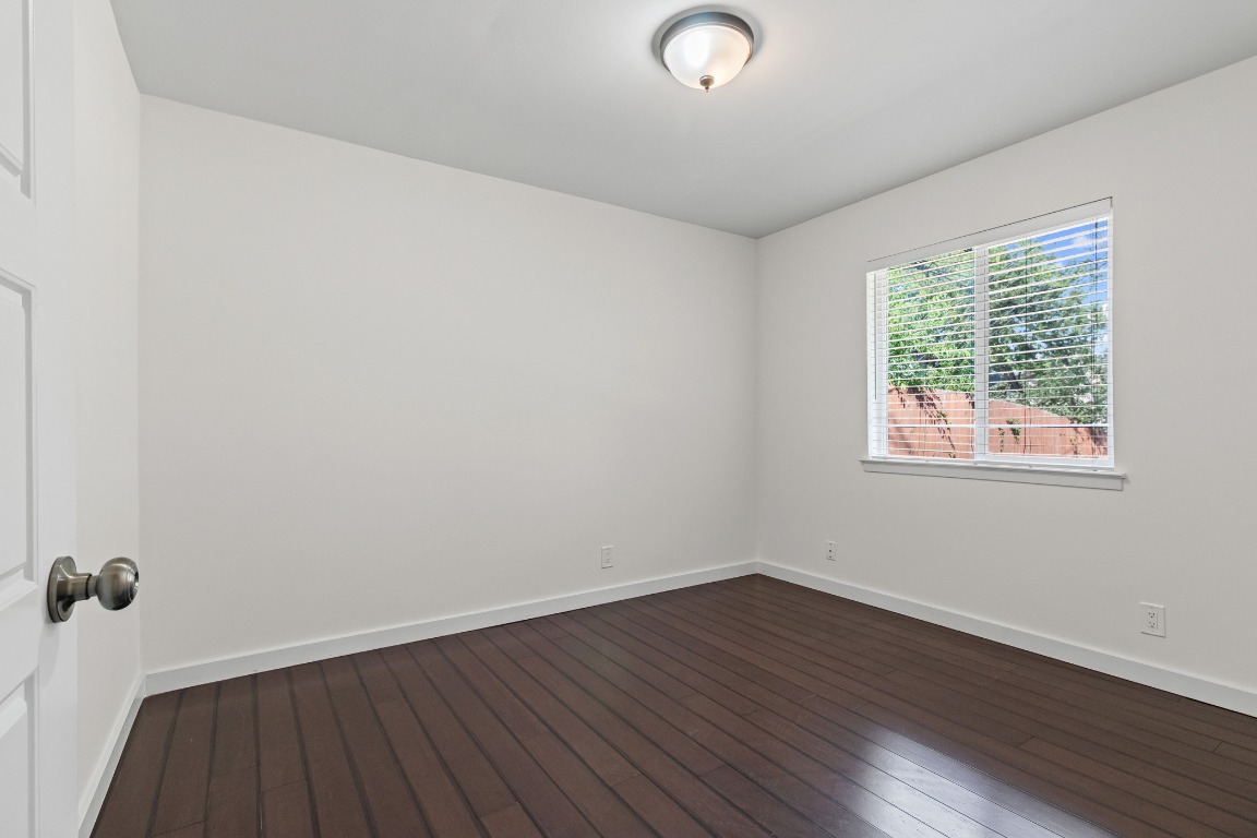 6305 Vioitha Drive, Unit B Austin, TX 78723 - Photo 16 of 23 wooden floor in an empty room with a window