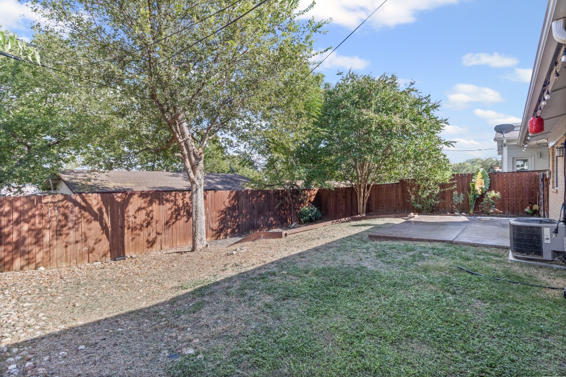 6305 Vioitha Drive, Unit B Austin, TX 78723 - Photo 19 of 23 a view of backyard with outdoor seating and green space