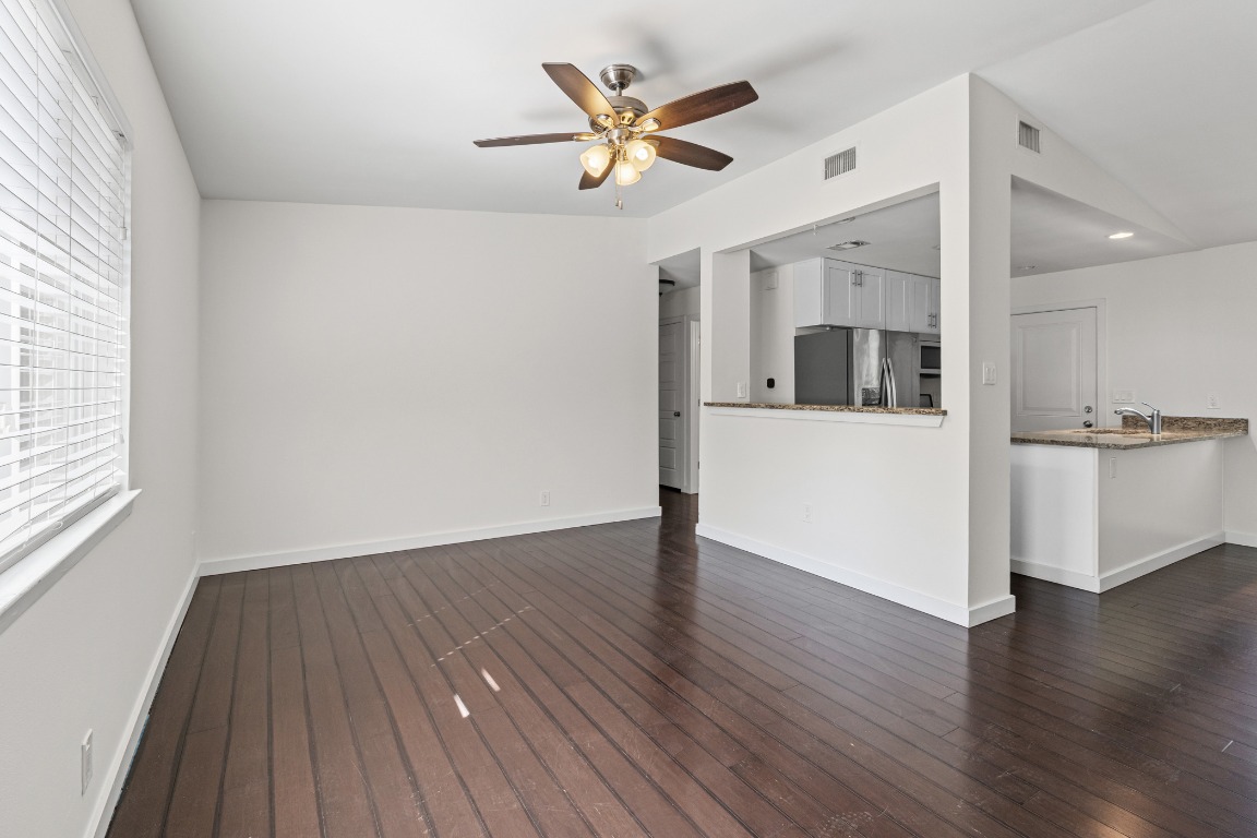 6305 Vioitha Drive, Unit B Austin, TX 78723 - Photo 4 of 23 a view of an empty room with window and wooden floor