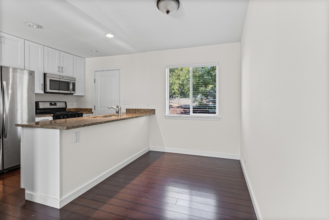 6305 Vioitha Drive, Unit B Austin, TX 78723 - Photo 5 of 23 a kitchen with a refrigerator and a stove top oven