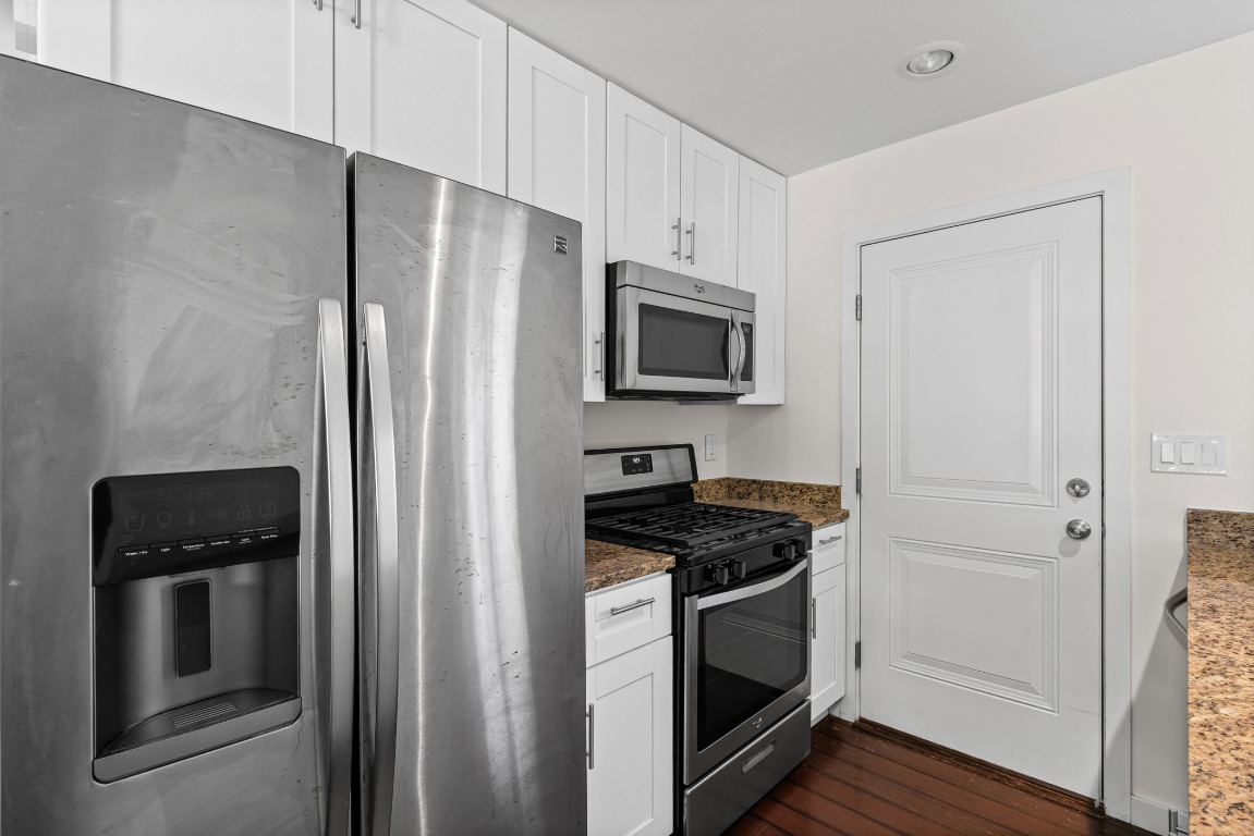6305 Vioitha Drive, Unit B Austin, TX 78723 - Photo 9 of 23 a kitchen with a refrigerator stove and microwave