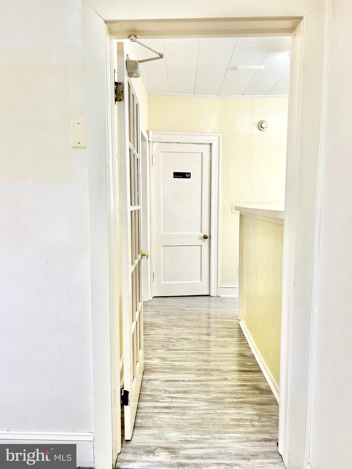 5904 Harford Road Baltimore, MD 21214 - Photo 15 of 23 a view of a hallway with wooden floor and a bathroom