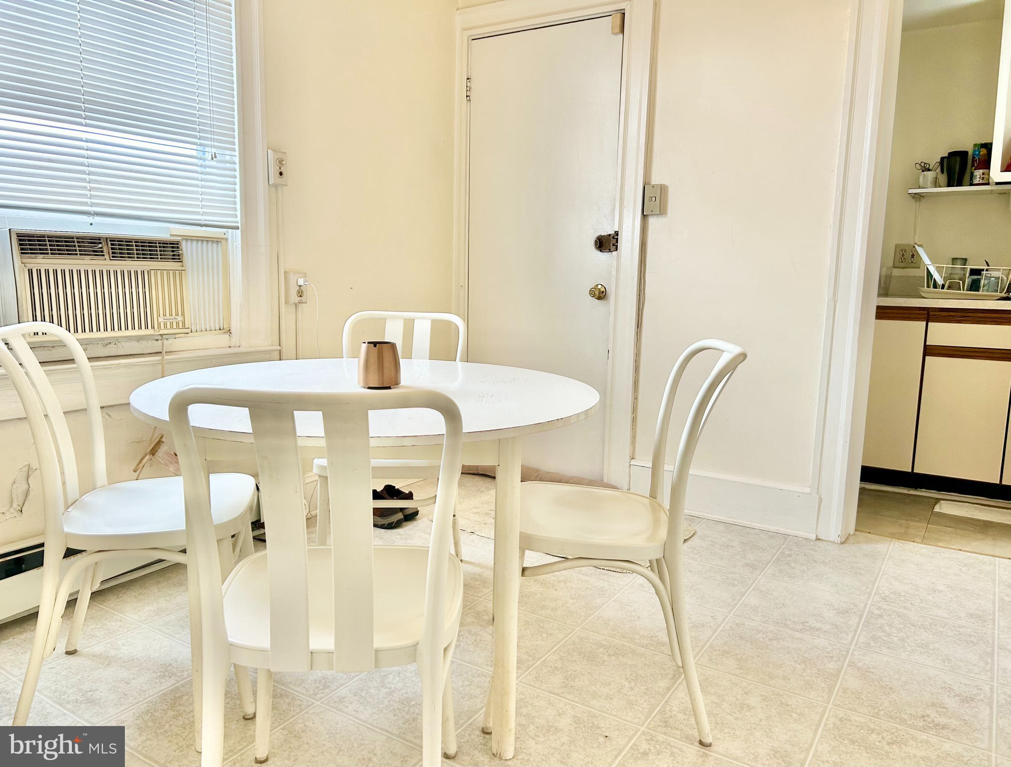 5904 Harford Road Baltimore, MD 21214 - Photo 5 of 23 a view of a dining room with furniture and a window