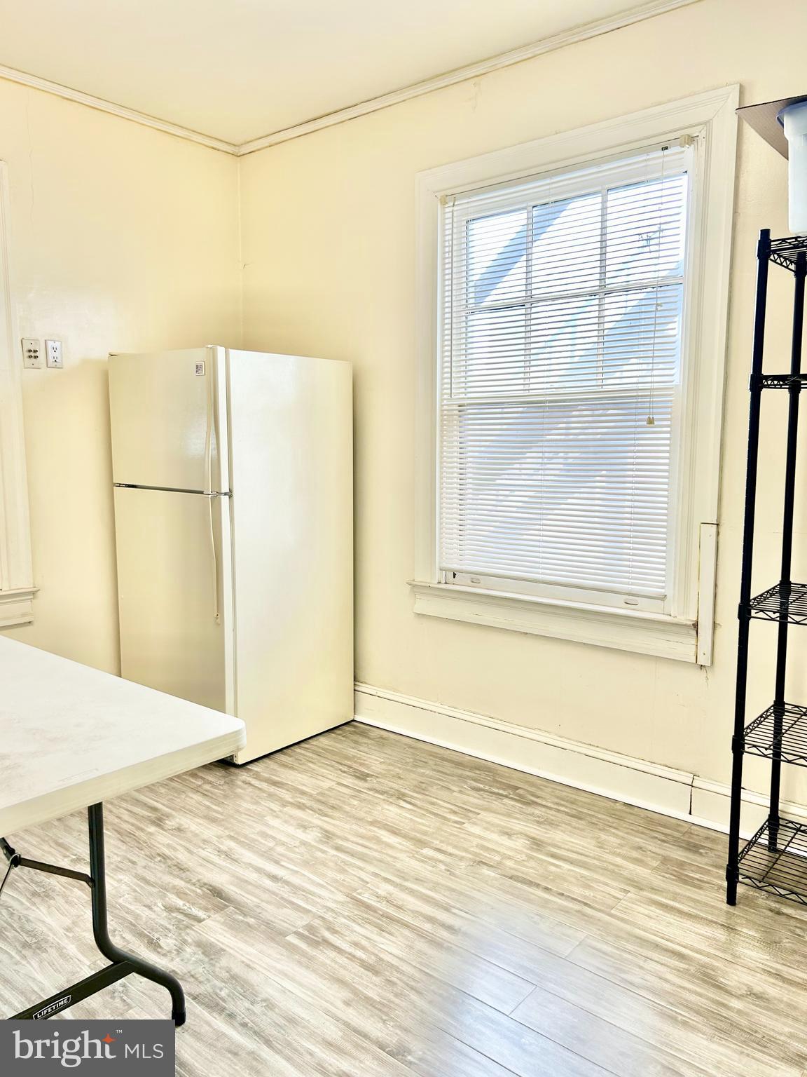 5904 Harford Road Baltimore, MD 21214 - Photo 10 of 23 a view of a room with wooden floor and a window
