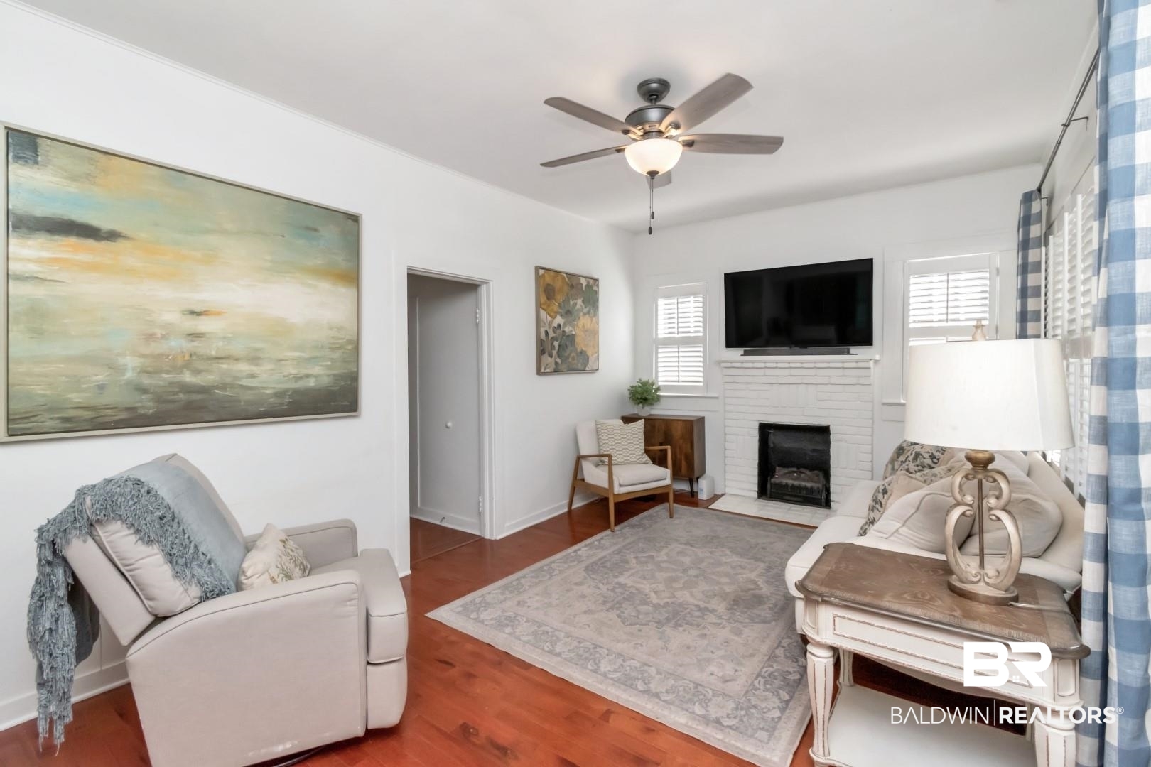 116 Item Avenue Mobile, AL 36607 - Photo 5 of 33 Living room with ceiling fan, dark hardwood / wood-style flooring, plenty of natural light, and a brick fireplace