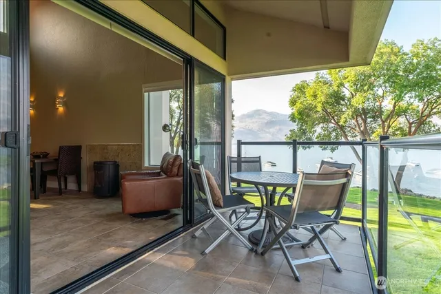 a view of an outdoor dining space with a table and chairs