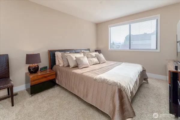 a bedroom with bed and window