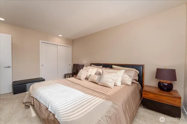 a bedroom with a bed and cabinets