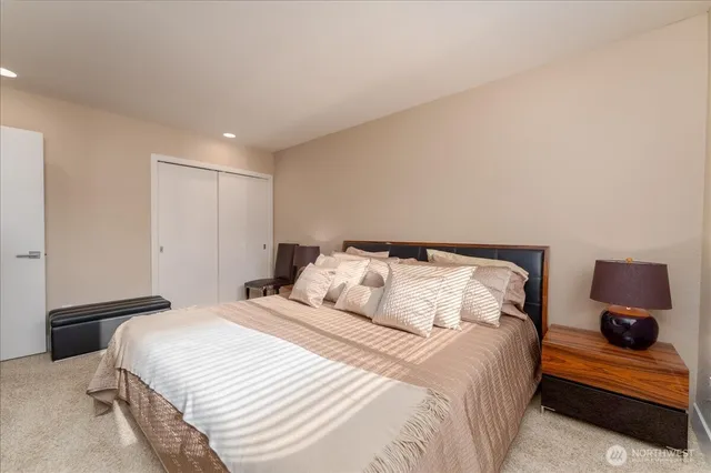 a bedroom with a bed and cabinets