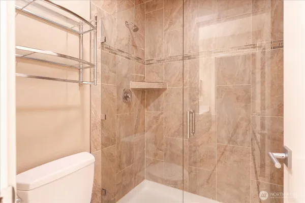 a bathroom with a shower and a toilet