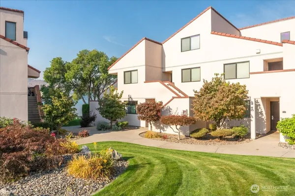 a view of a white house with a yard