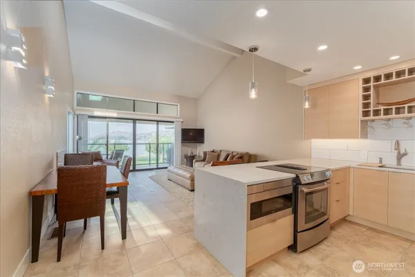 a kitchen with a stove a table and chairs