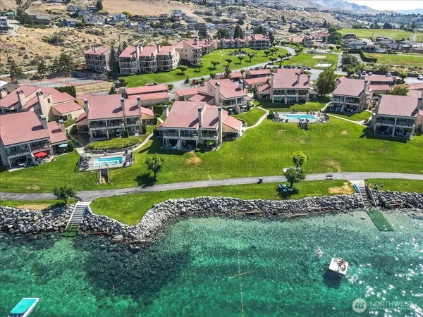 an aerial view of a house with a garden and mountain view in back
