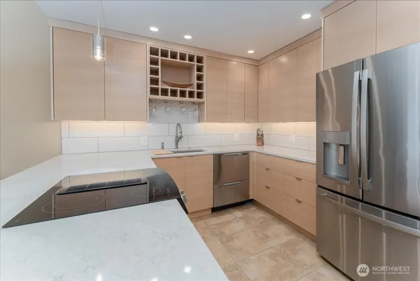 a large kitchen with kitchen island a sink stainless steel appliances and cabinets