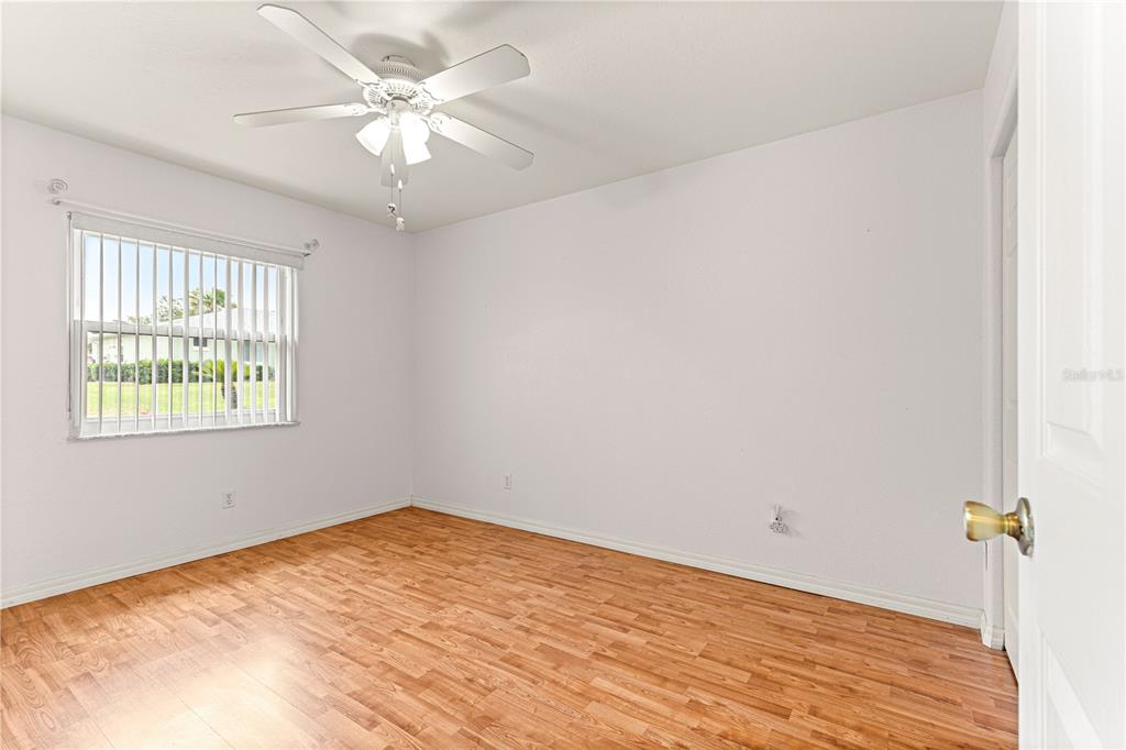 9958 Southwest 59th Circle Ocala, FL 34476 - Photo 25 of 56 wooden floor in an empty room with a window