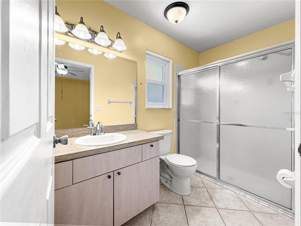 9958 Southwest 59th Circle Ocala, FL 34476 - Photo 29 of 56 a bathroom with a granite countertop sink toilet and shower