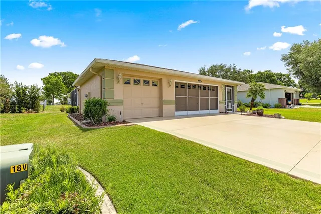 a view of a house with backyard and sitting area