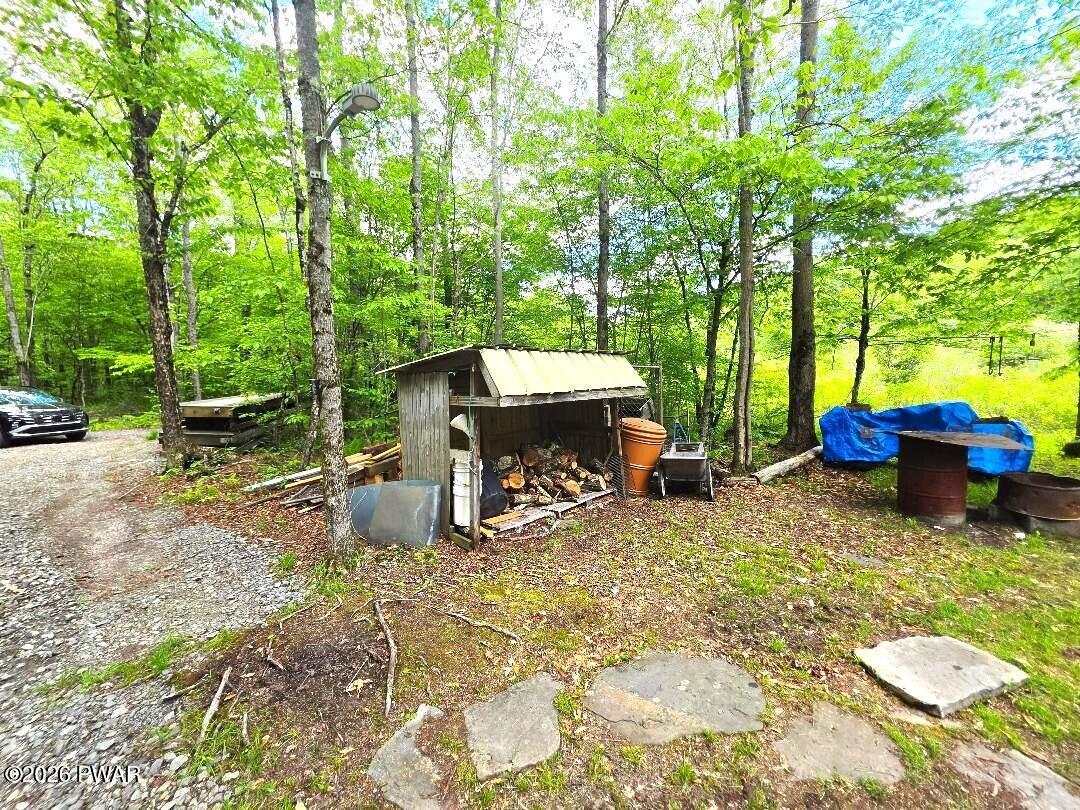 94 Swamp Road Pleasant Mount, PA 18453 - Photo 22 of 33 a view of a chairs and table in backyard