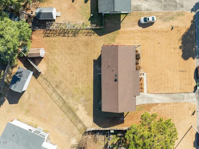 an aerial view of a house with a yard