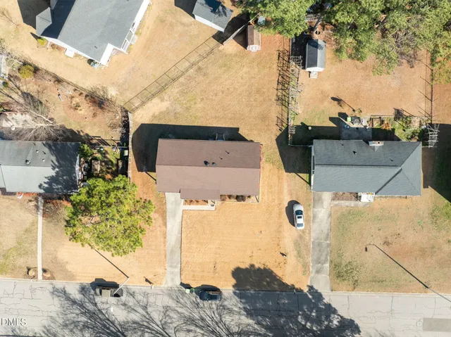 a view of a bedroom with wooden floor and windows
