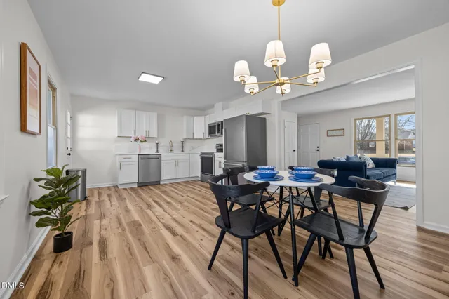 a view of a dining room with furniture wooden floor and chandelier