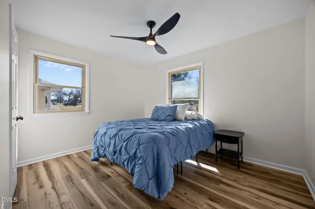 a bed sitting in a bedroom next to a window