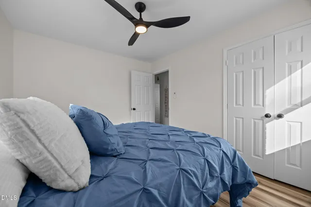 a bedroom with a bed and a potted plant