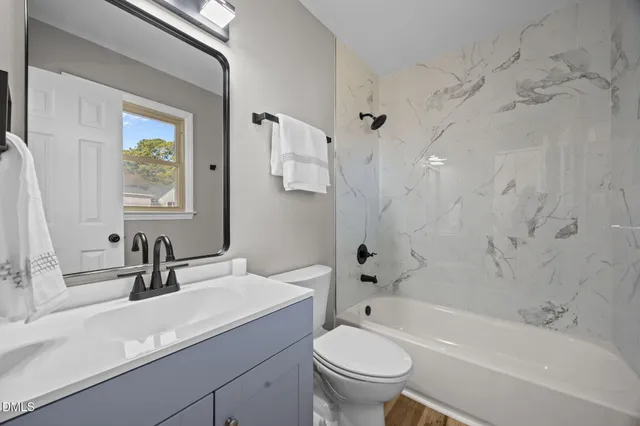 a bathroom with a sink a toilet and a bathtub