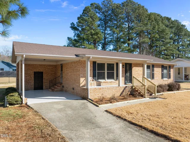 a front view of a house with a sitting area