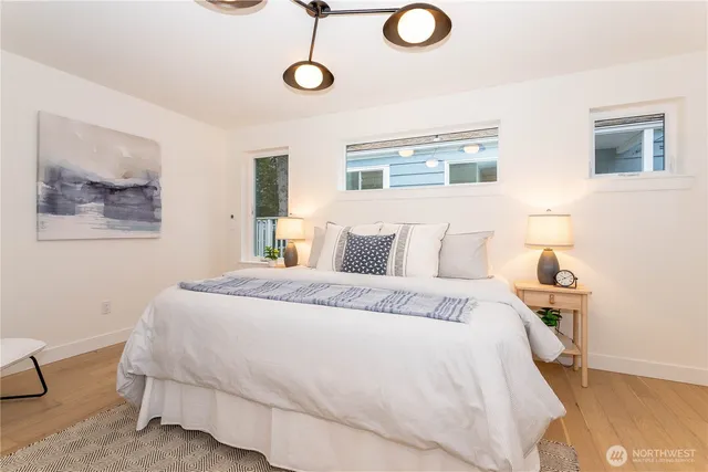 a bed room with a bed mirror and a window