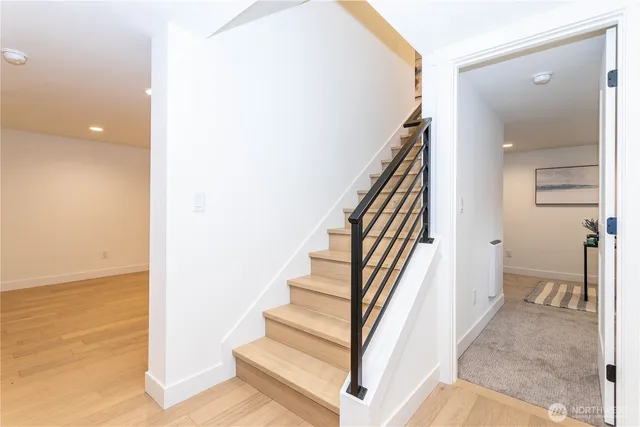 a view of entryway and hall with wooden floor