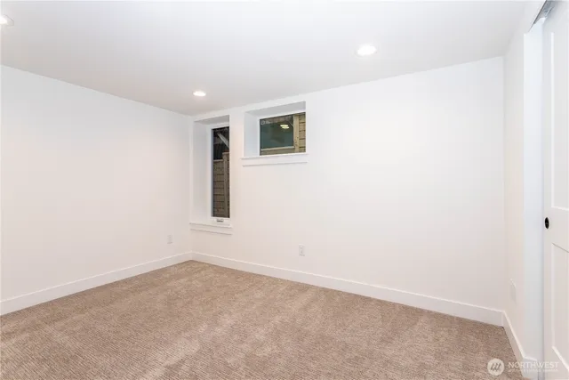 a bathroom with a granite countertop sink a toilet and a mirror